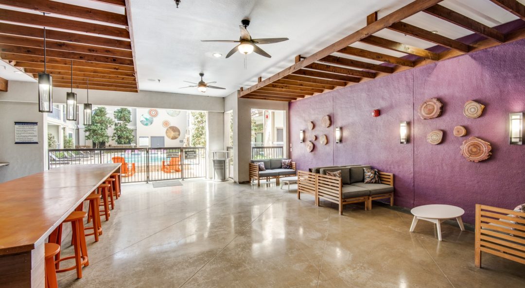 the lobby of a hotel with purple walls and purple ceiling at The NEO Midtown