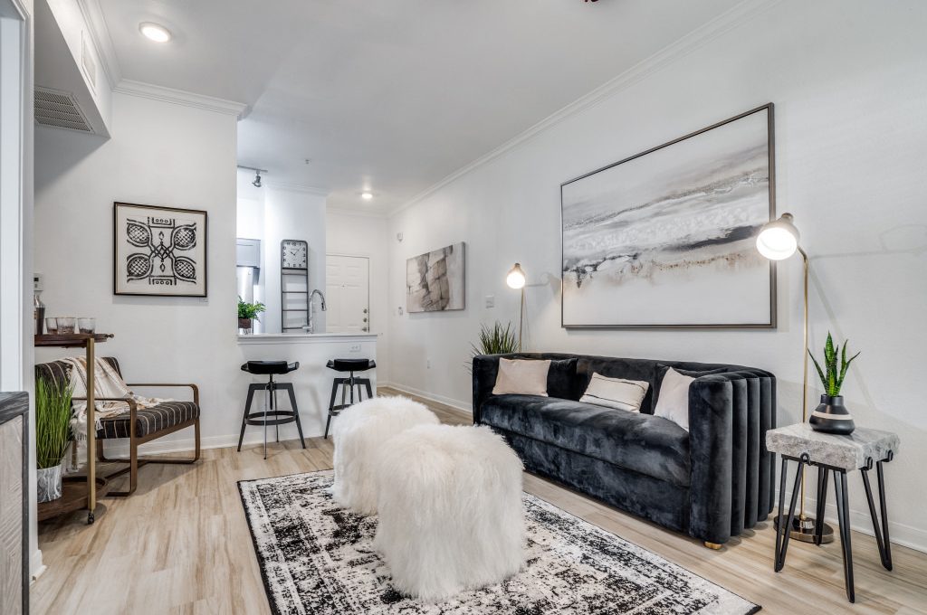 a living room with a rug and a couch at The NEO Midtown