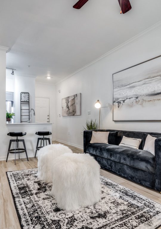 a living room with a rug and a couch at The NEO Midtown